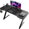 Escritorio gaming 120×60 cm con superficie tipo fibra de carbono, iluminación LED y enchufe integrado – estructura metálica en forma de Z color negro